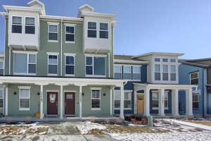 Townhome / multi-family property featuring covered porch