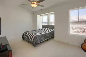 Bedroom featuring ceiling fan, lofted ceiling, and carpet floors