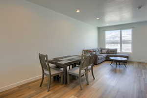 Dining space with light hardwood / wood-style flooring