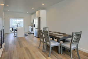 Dining space featuring sink and light hardwood / wood-style flooring