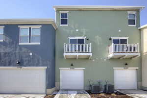 Rear view of property featuring cooling unit