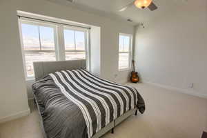 Carpeted bedroom with ceiling fan