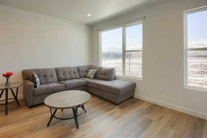 Living room with light hardwood / wood-style floors