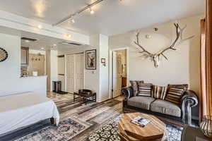 Bedroom featuring light hardwood / wood-style flooring and a closet