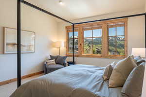 Bedroom with carpet floors and baseboards