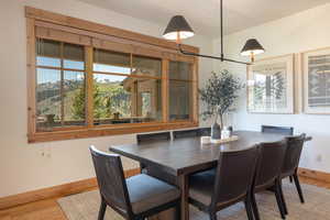 Dining space with wood finished floors and baseboards