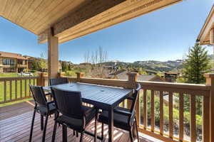 Deck with outdoor dining space, a mountain view, and a residential view