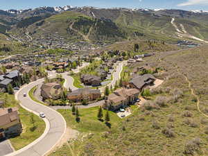 Aerial view of property's location with a mountain backdrop and nearby suburban area