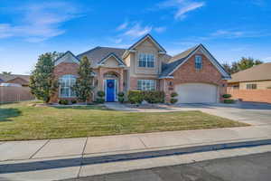 View of front facade with a garage and a front yard