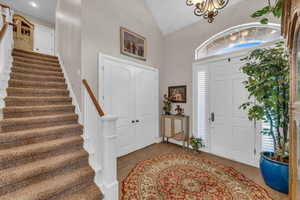 Entryway featuring lofted ceiling, hardwood / wood-style flooring, and a healthy amount of sunlight