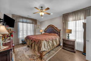 Bedroom with ceiling fan and light hardwood / wood-style floors