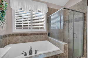 Bathroom with separate shower and tub and lofted ceiling