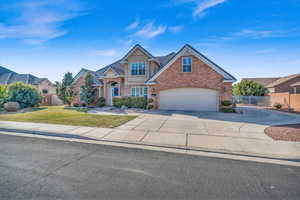 View of front of house with a garage and a front yard