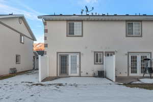 Snow covered house with central AC