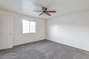 Unfurnished room featuring carpet floors and ceiling fan