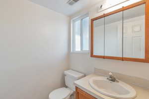 Bathroom featuring vanity and toilet