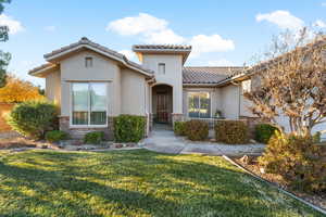 Mediterranean / spanish house with a front yard