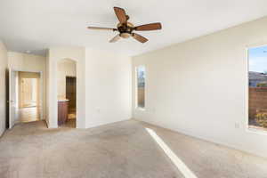 Unfurnished room with light colored carpet and ceiling fan