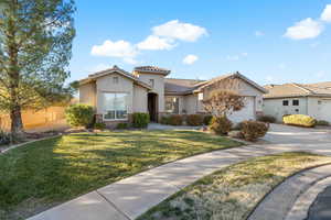 Mediterranean / spanish-style home featuring a garage and a front lawn