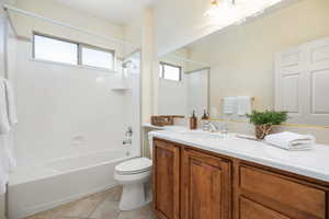 Full bathroom featuring vanity, tile patterned floors, bathing tub / shower combination, and toilet