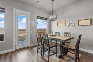 Dining area featuring dark hardwood / wood-style flooring and a chandelier