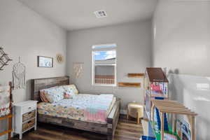 Bedroom with dark wood-type flooring