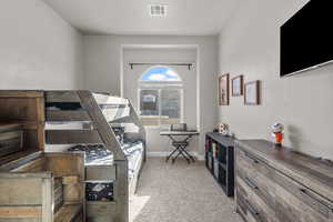 Bedroom featuring light colored carpet