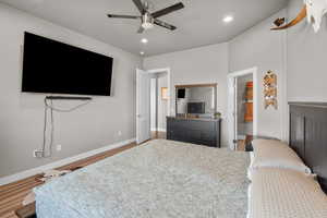 Bedroom with hardwood / wood-style floors and ceiling fan