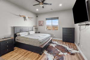 Bedroom featuring ceiling fan and light hardwood / wood-style floors