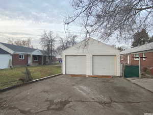 Garage featuring a lawn