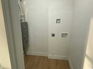 Clothes washing area featuring hookup for a washing machine, hardwood / wood-style flooring, and hookup for an electric dryer