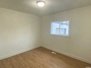 Spare room with light wood-type flooring