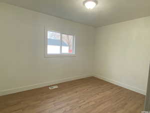 Unfurnished room with hardwood / wood-style flooring