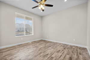 Spare room with light hardwood / wood-style floors and ceiling fan