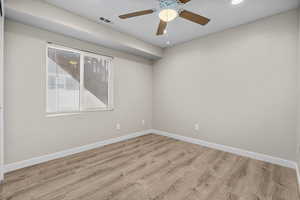 Spare room with ceiling fan and light hardwood / wood-style flooring