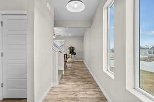 Corridor with light hardwood / wood-style flooring