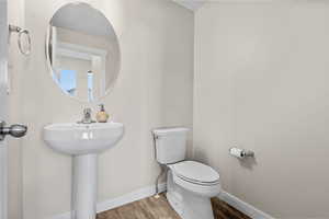 Bathroom with wood-type flooring and toilet