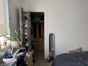 Bedroom featuring a closet and wood-type flooring