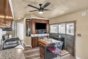 Interior space with hardwood / wood-style flooring, lofted ceiling, sink, and a textured ceiling