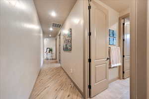 Hall with light hardwood / wood-style floors