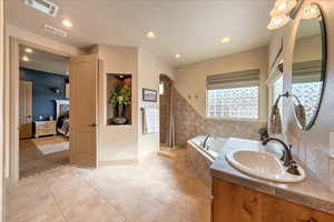 Bathroom with vanity, plus walk in shower, and tile patterned flooring