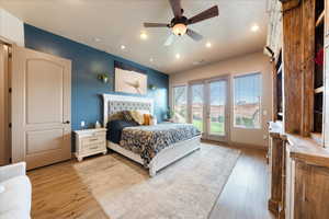 Bedroom featuring ceiling fan, hardwood / wood-style floors, and access to outside