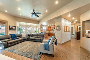 Living room featuring ceiling fan, a healthy amount of sunlight, and light wood-type flooring