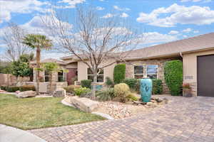 View of front facade featuring a garage and a front yard