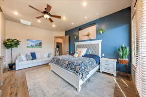 Bedroom featuring ceiling fan and wood-type flooring