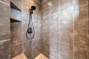 Bathroom featuring tiled shower