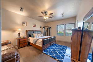 Bedroom with ceiling fan and a textured ceiling