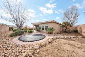 Rear view of property with a playground