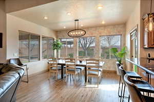 Dining area featuring a notable chandelier and light hardwood / wood-style floors