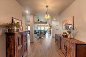 Corridor with light hardwood / wood-style floors and a textured ceiling